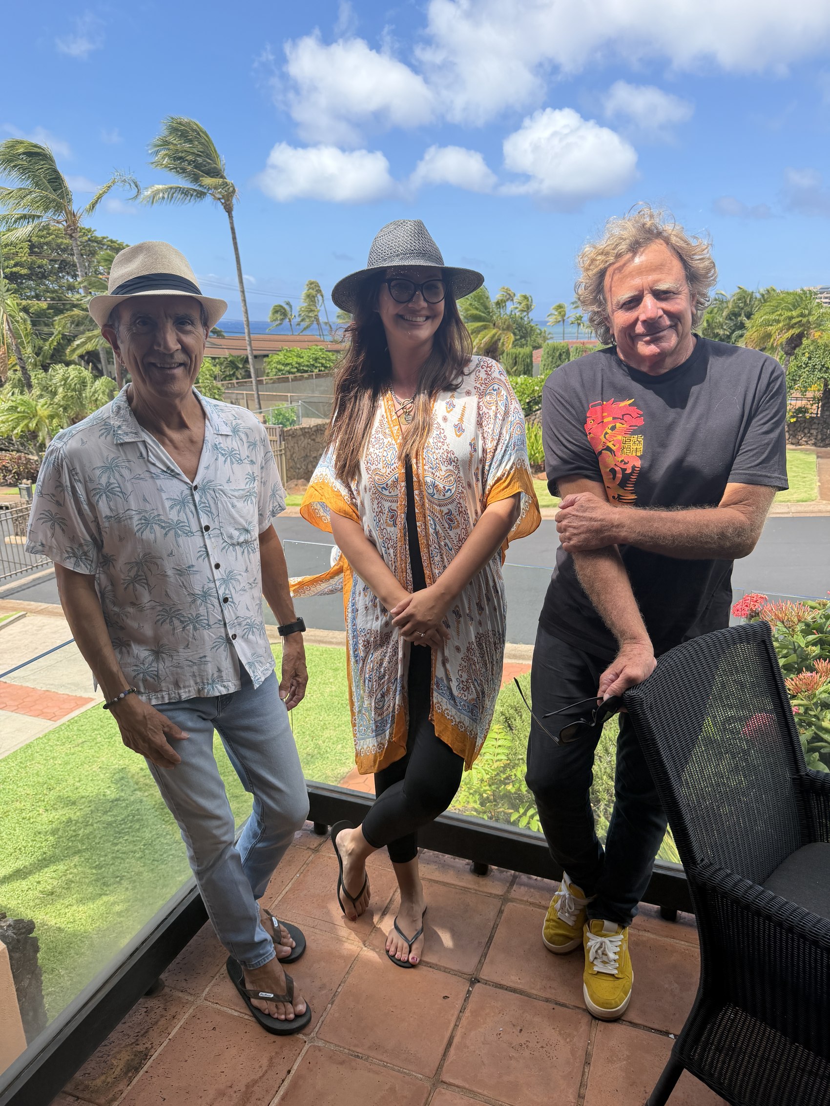Barney Cortinez, Kris Bradley and Shawn McLaughlin on a Maui balcony with the ocean behind them.